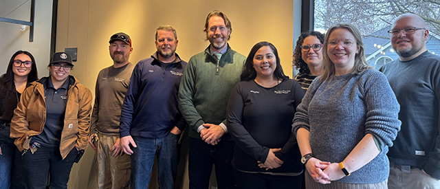 A group of nine staff members.