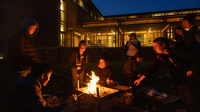 Students around a campfire at night