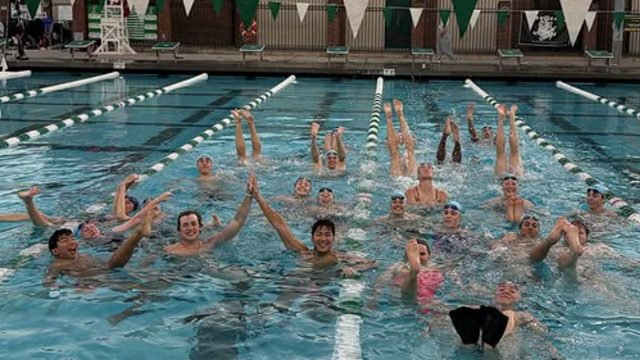 A large group of Whitman swimmers floating in a pool