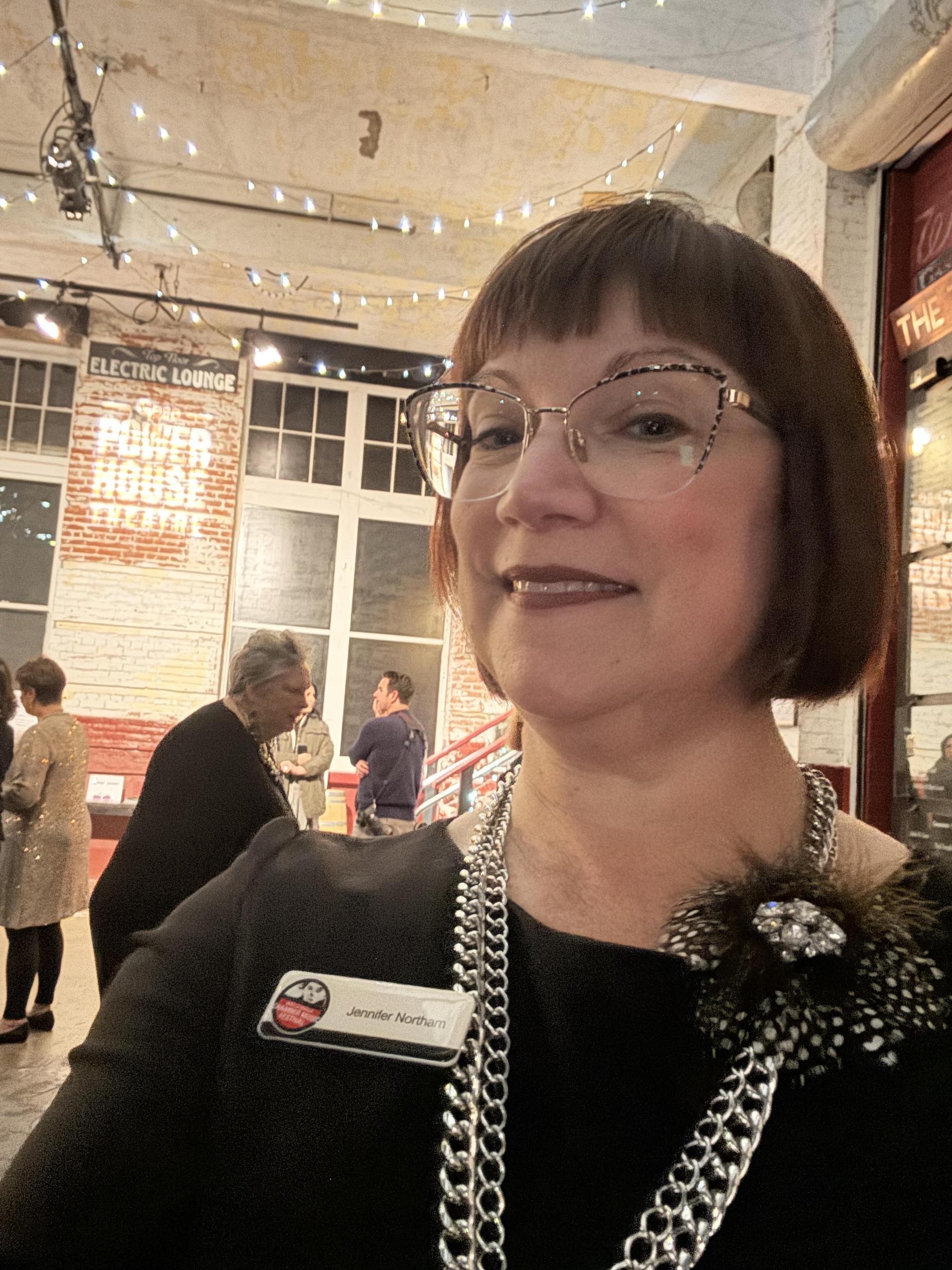 Portrait of Jennifer Northam, standing in the lobby of Gesa Power House Theatre.