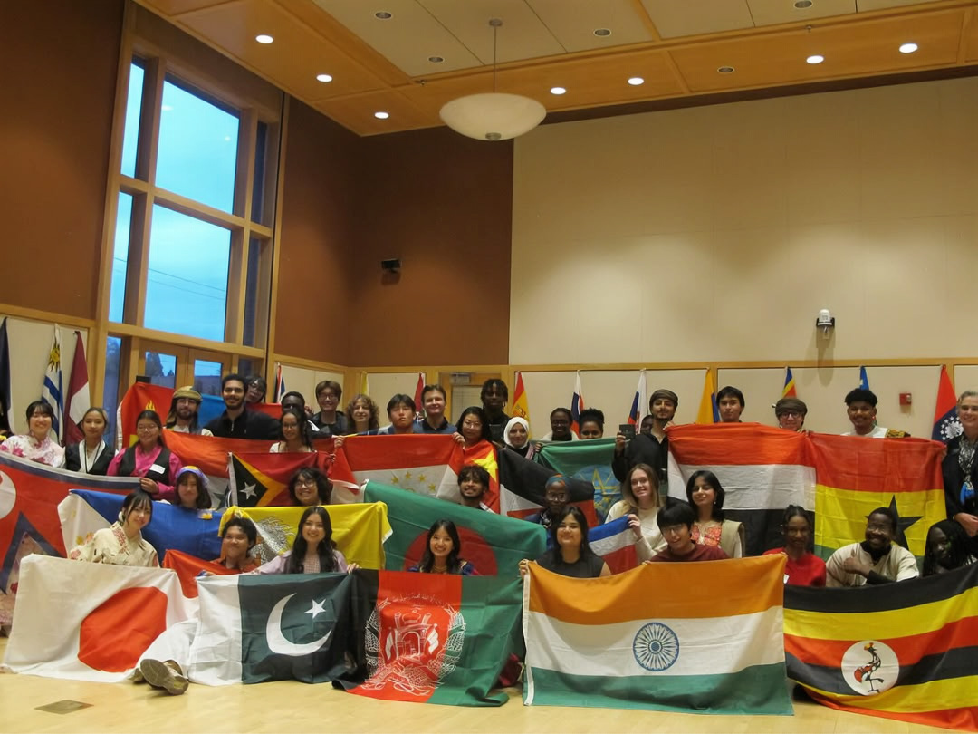 Students holding flags from different countries 