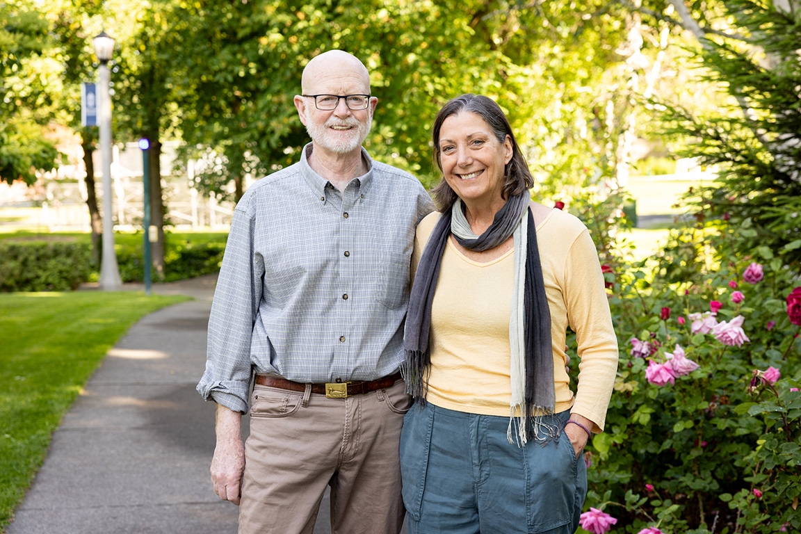 Dan Hoch ’75 and Jane Erb standing together outside on Whitman campus.