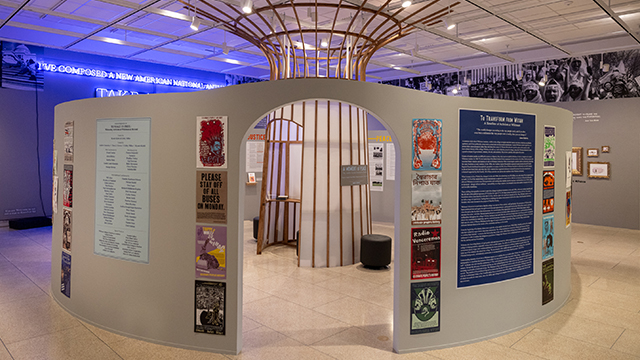 An exhibition on display in Sheehan Gallery with circular walls creating a smaller room in the larger gallery space