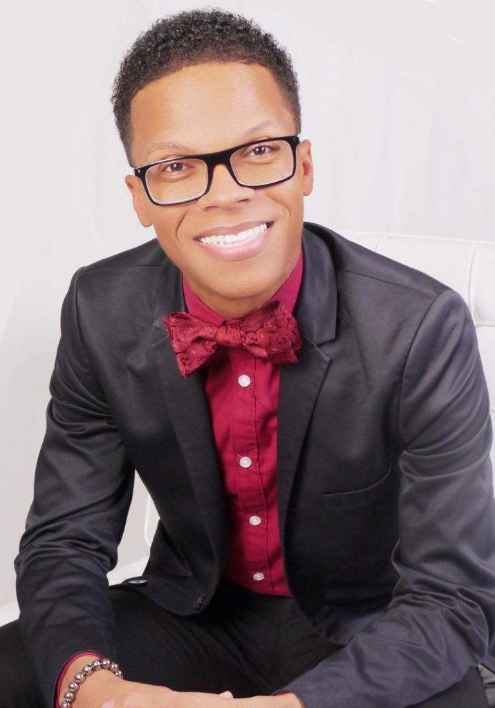 Portrait of Terrell Strayhorn wearing a red shirt and bowtie with a dark gray jacket.