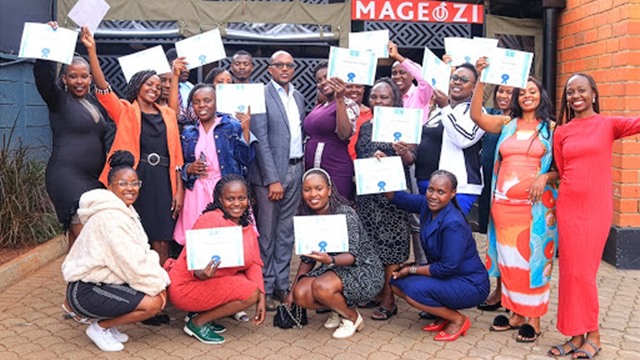 A group of Kenyan small-business owners holding up certificates.