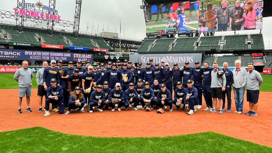 Whitman Blues players pose with the Mariners team at T-Mobile Park.