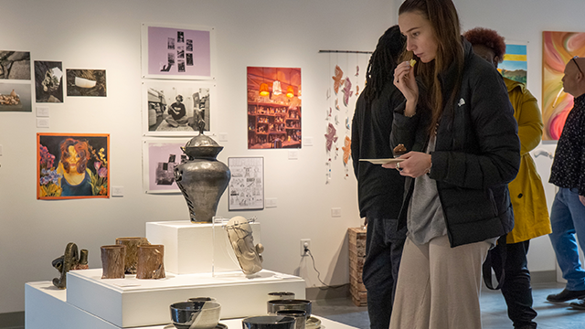 Several people browsing an art exhibition.