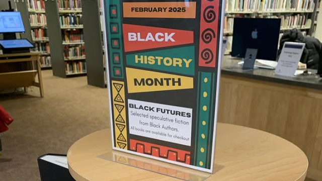 A colorful sign on a table with text including “February 2025,” “Black History Month” and “Black Futures”