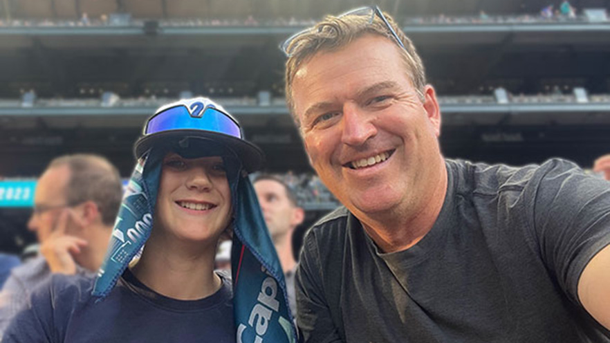 Andrew Reed (right) and his son (left) take a selfie at a baseball stadium.