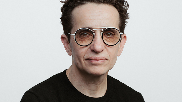 Portrait of M. Gessen, wearing a black shirt and black circle-rimmed glasses. Photo credit: Damon Winter.