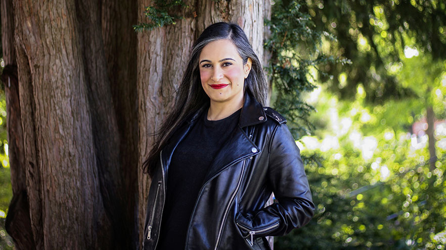 Portrait of Taha Ebrahimi, standing in front of a large tree.