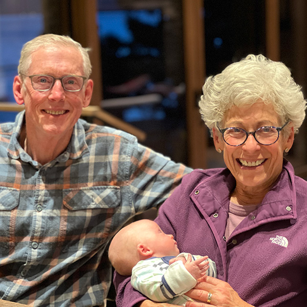 Greg and Nancy Serrurier; Nancy is holding their infant grandson.