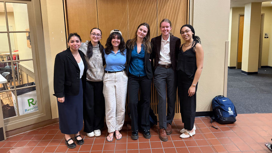 A group photo of six members of the Whitman Debate & Forensics Team.