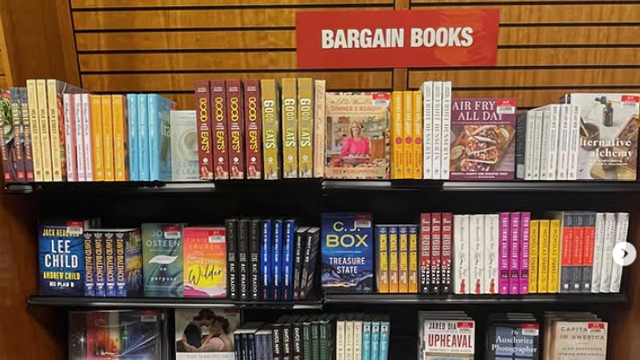A shelf full of books and a sign that reads “Bargain Books”.