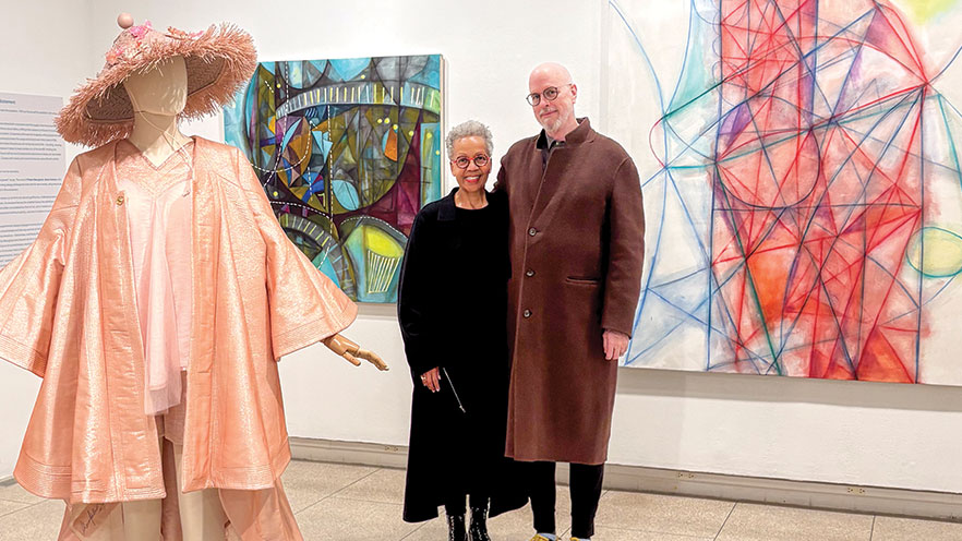 Rhonda P. Hill (left) and Erik ReeL ’75 (right) stand together in an art gallery space.