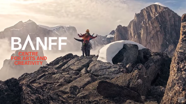 Several climbers walk across a rocky area with tall mountain peaks in the background. White and red text reads “Banff Centre for Arts and Creativity”