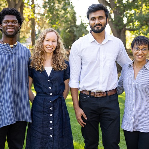 The 2025 Faculty Fellows standing outside Reid side lawn; from right to left: Mylan Gray, Emma Rossby, Zarif Rahman and Nicole Cox