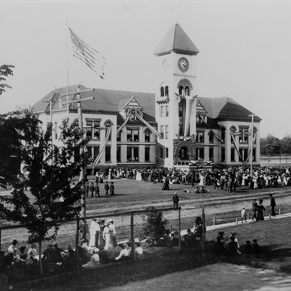 A historical black and white photo of Commencement in front of Memorial Building 
