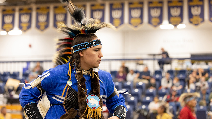 Aiden Wolf ’26 dressed in Native American regalia.