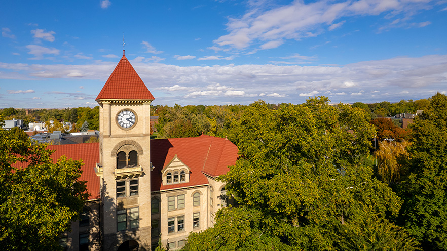 An aerial view of Memorial Building rising up above the nearby trees.