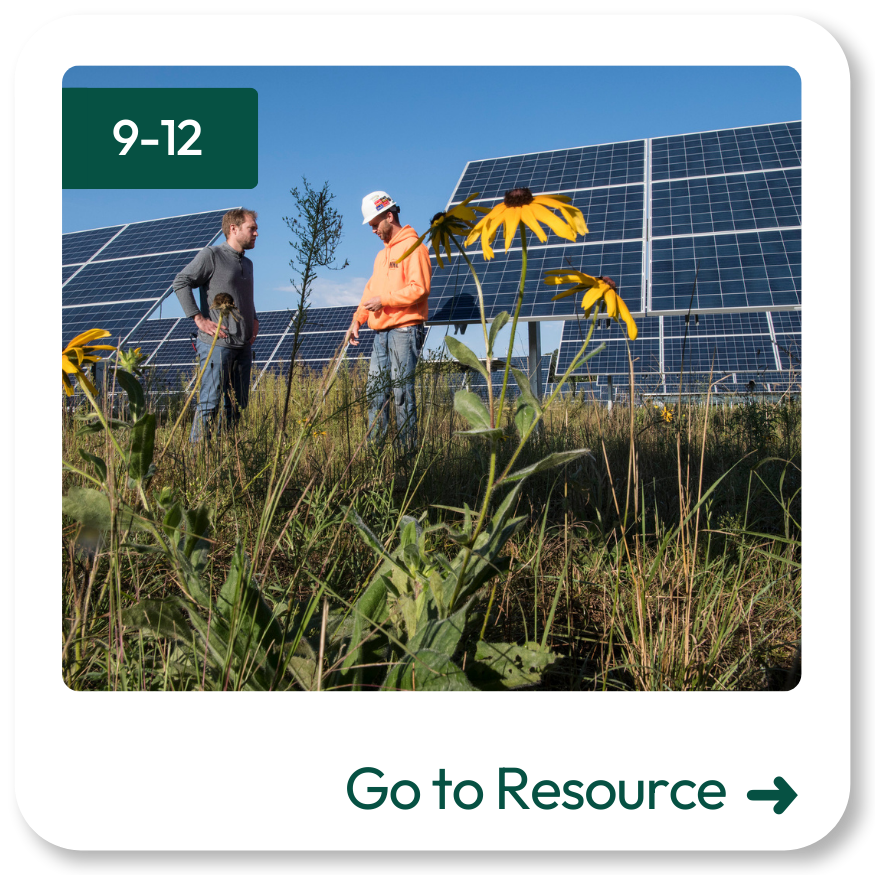 Photo of workers in front of solar panels
