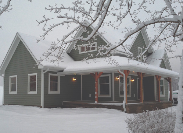 Two story house covered with snow