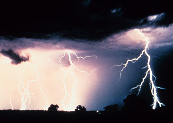 Lots of lightning flashing in a dark storm.