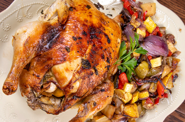 Baked turkey plated next to vegetable blend.