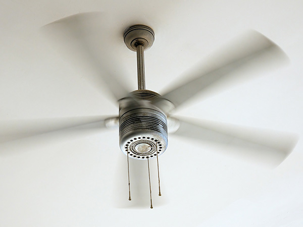 Silver ceilling fan in motion.