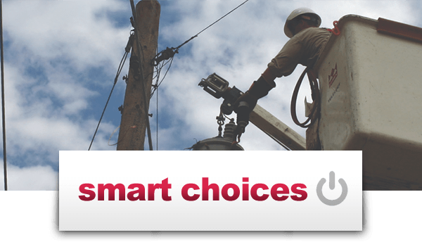 Smart Choices - Photo: lineman in bucket truck bucket near top of power line pole