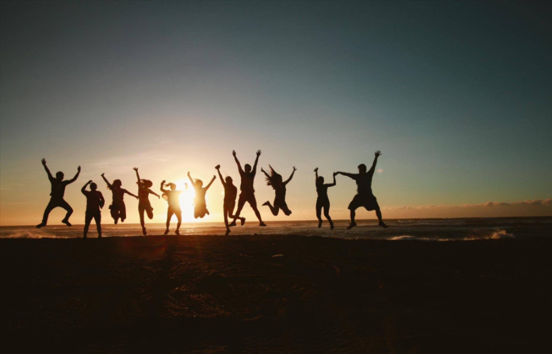 Silhouettes of people jumping in the air