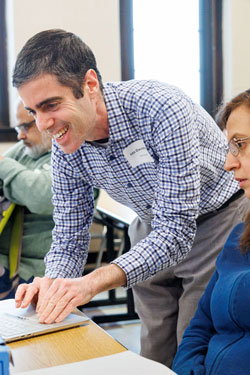 Ido Davidesco helps participants in an AI and engineering workshop at Boston College