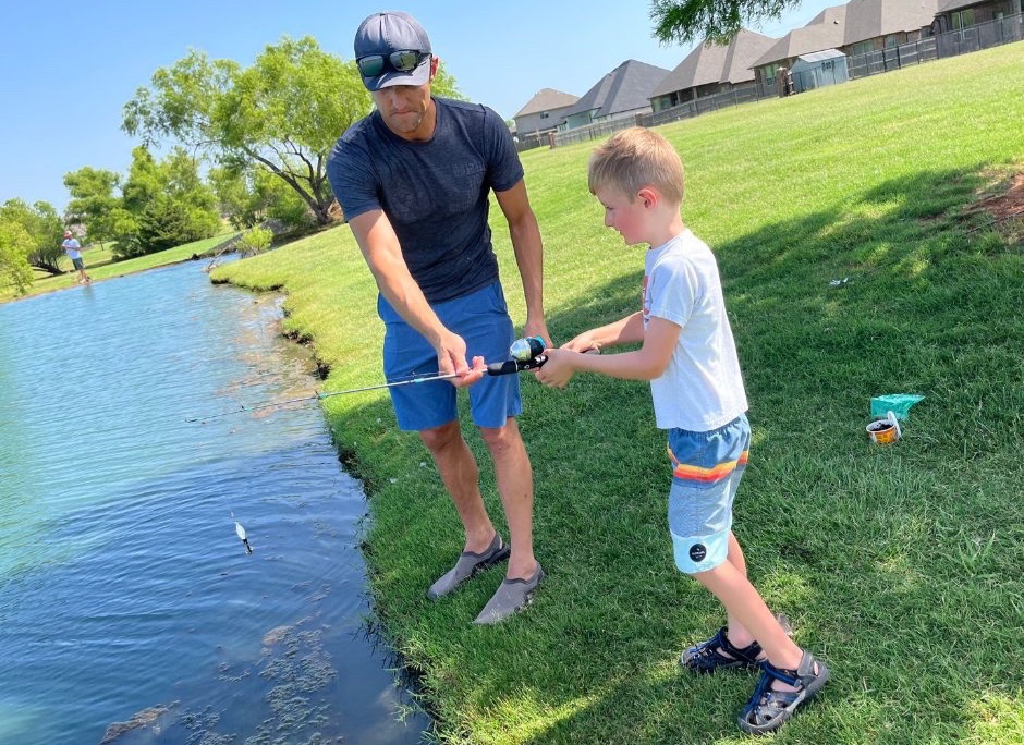 Father and son fishing in Morgan Creek community pond.