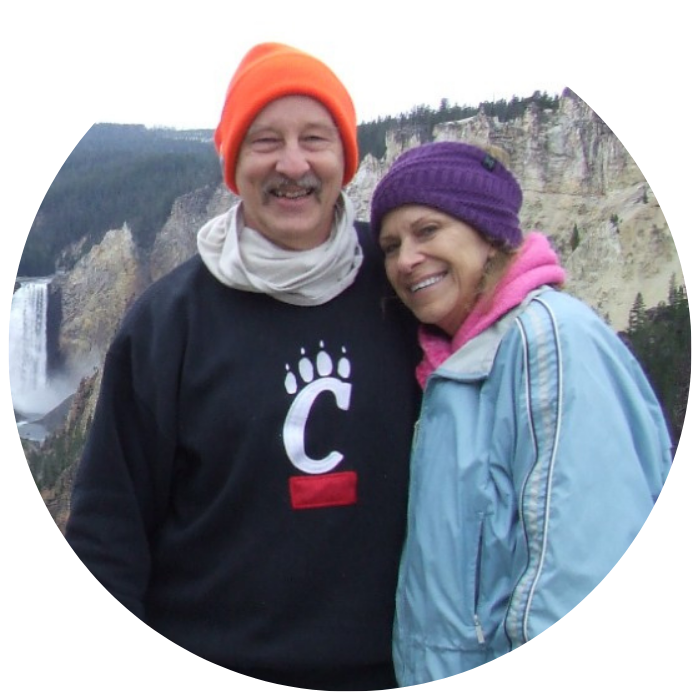 A bearcat couple posed in front of a scenic canyon.