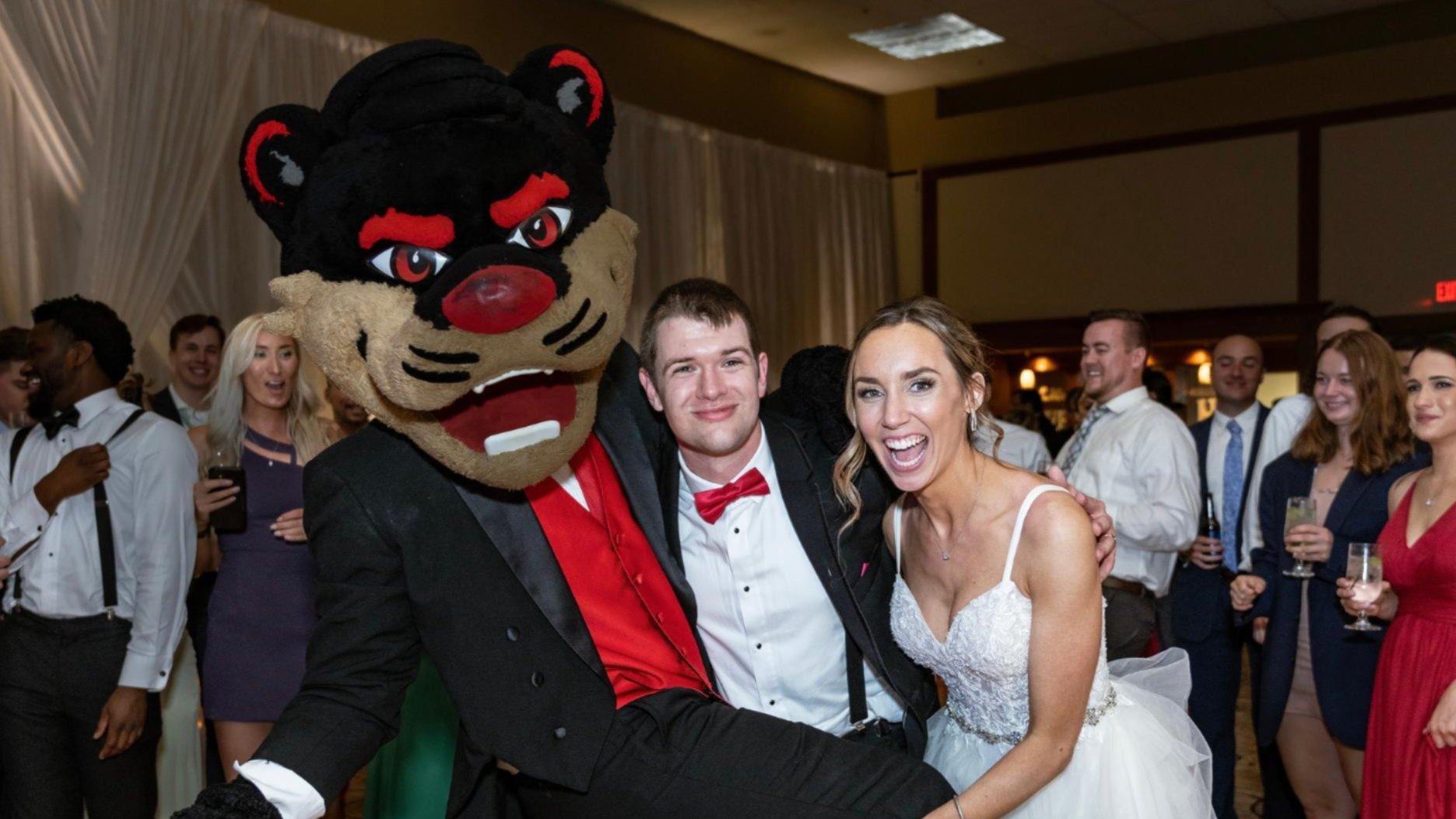 UC Alumni at their wedding posing with Bearcat