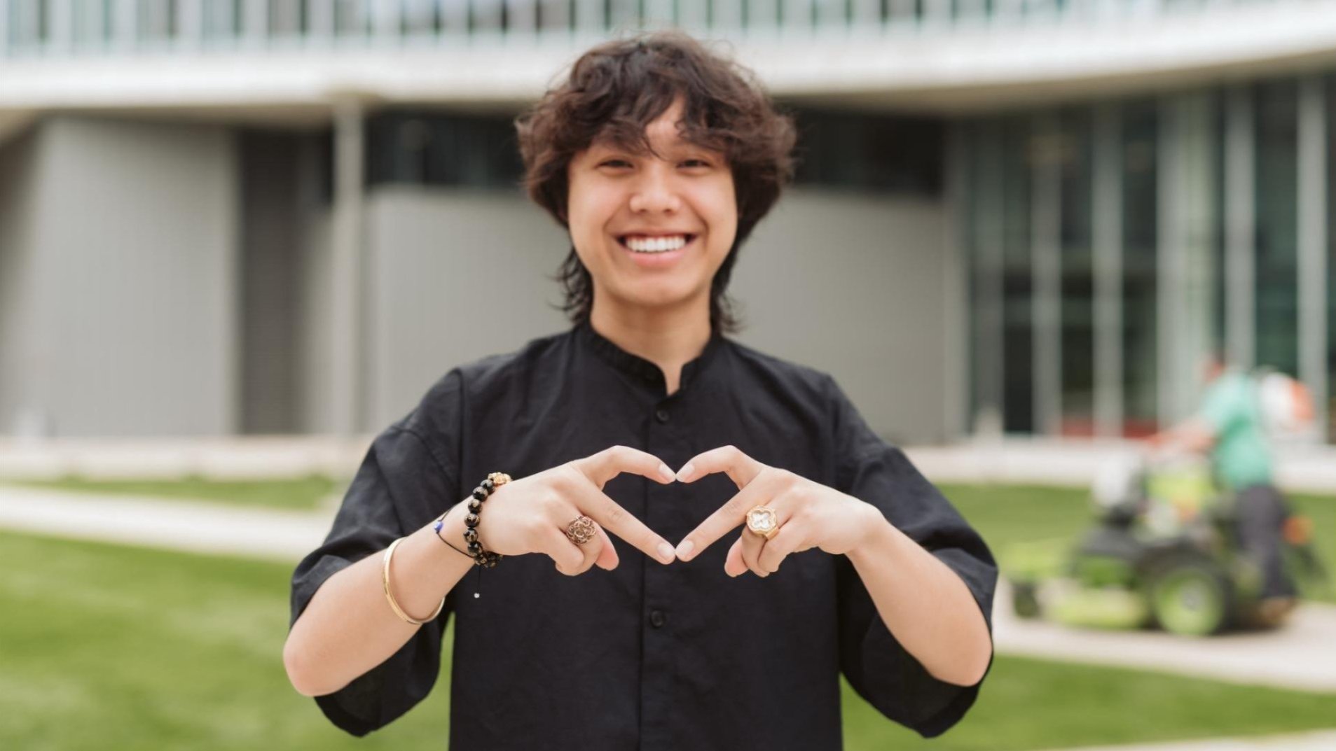 UC student making a heart shape with their hands