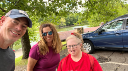 Jude Schramm, Kristen Schramm and Erin Marie Schramm smiling in a park