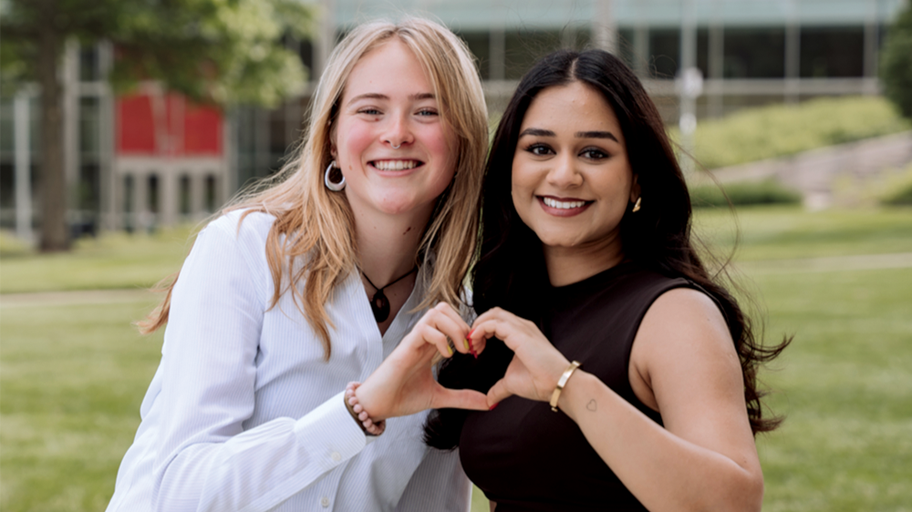 Students making heart with hands