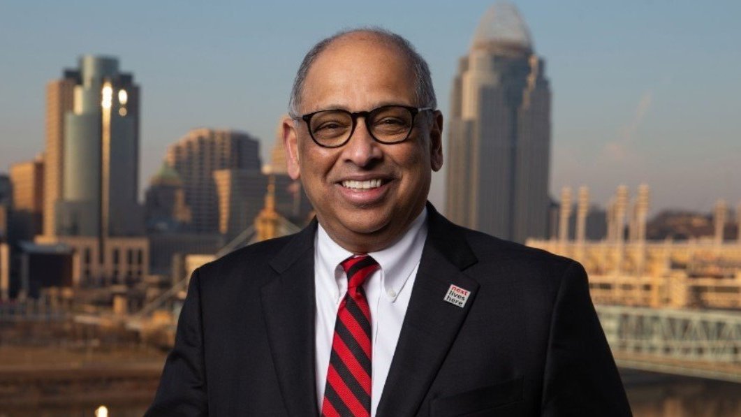 UC President Neville G. Pinto in front of the Cincinnati skyline