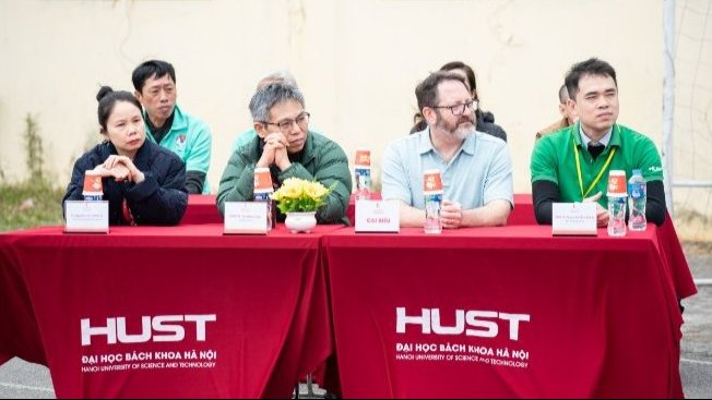 A group of professors sits at a table answering questions.