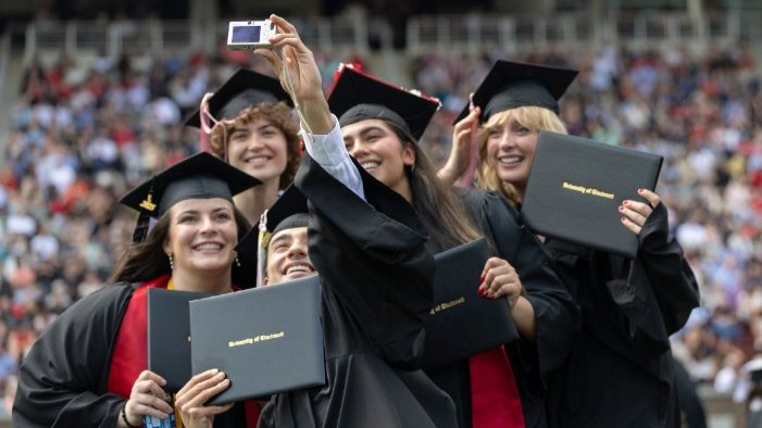 UC graduates taking a selfies