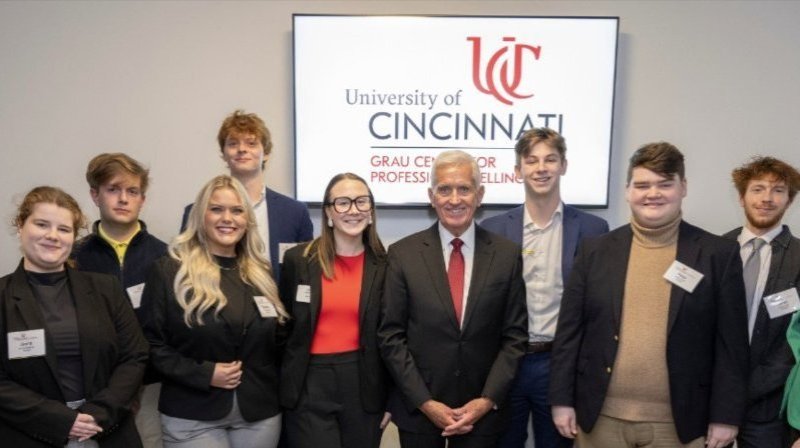 UC students posing with Jim Grau