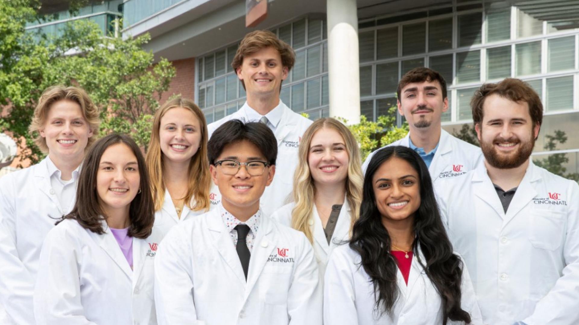 Nine medical students in front of Care Crawley building.