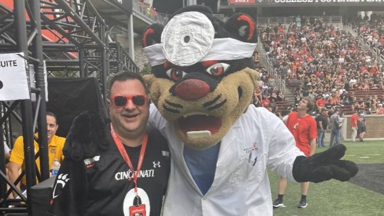 Peltier posing with the Bearcat mascot