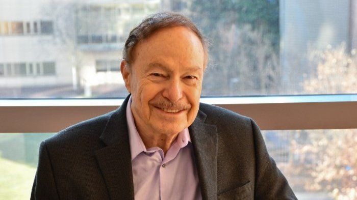 Professor Ephraim Gutmark, smiling in front of a window.