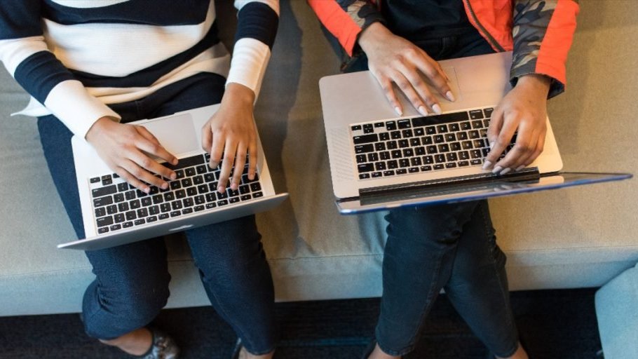 Hands typing on a laptops