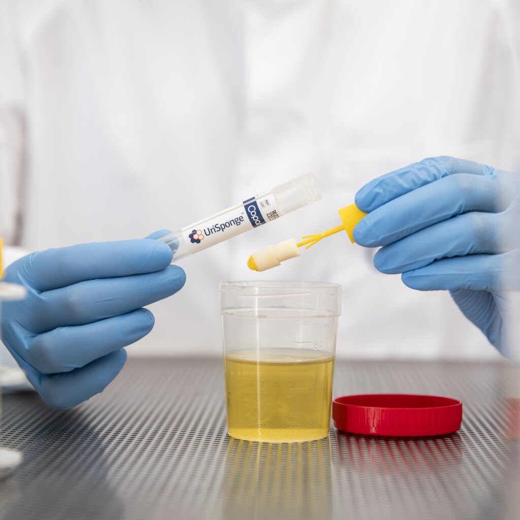 a person holding a tube with a yellow object in it