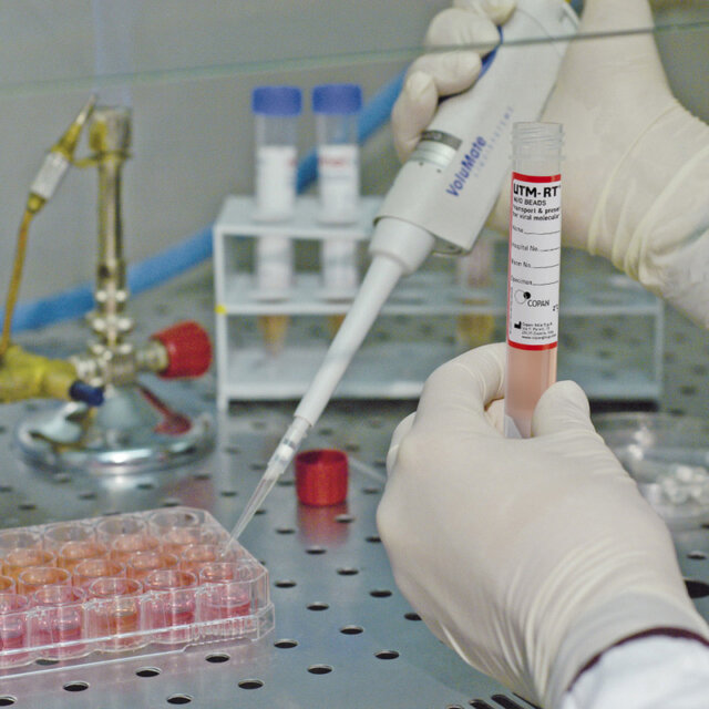 a person holding a tube with a yellow object in it