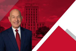 Image of Houston Mayor John Whitmire in navy suit and red tie with red background