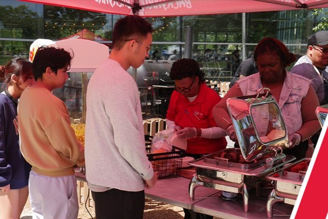 UH dining staff serving students at Cougar Woods Dining Commons